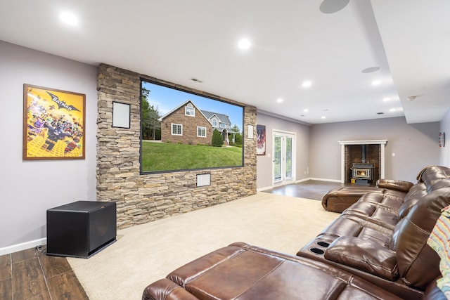 living room with dark hardwood / wood-style floors and a wood stove