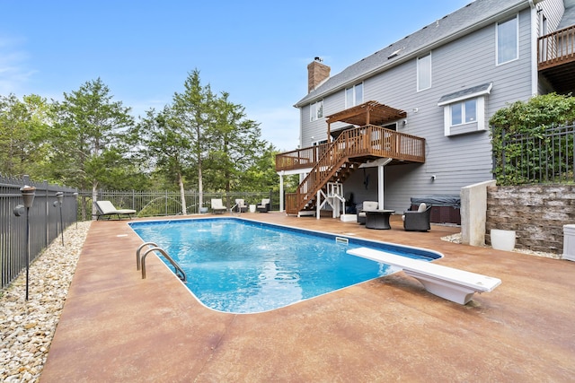 view of swimming pool featuring a pergola, a deck, a patio, and a diving board