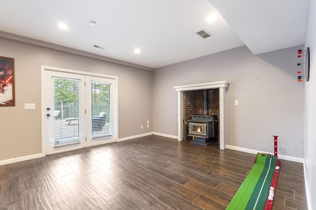 interior space featuring dark hardwood / wood-style floors and a wood stove