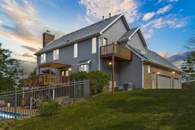 back house at dusk featuring a balcony, a lawn, a garage, a pergola, and a fenced in pool