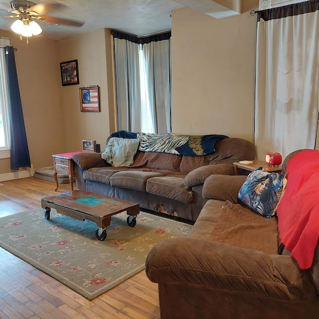 living room featuring light hardwood / wood-style floors and ceiling fan