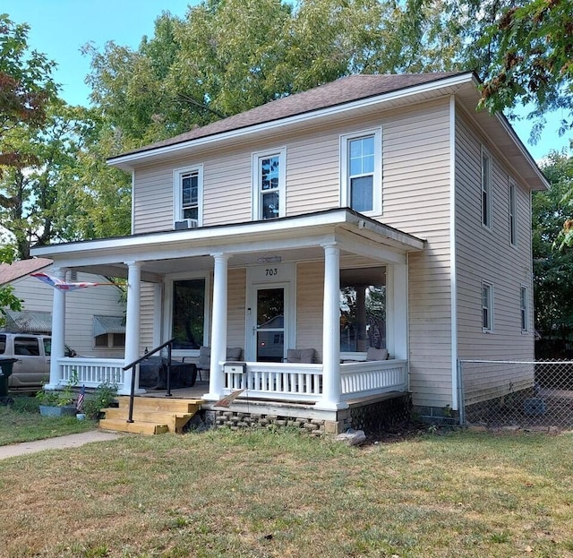 view of front of property with a porch and a front lawn