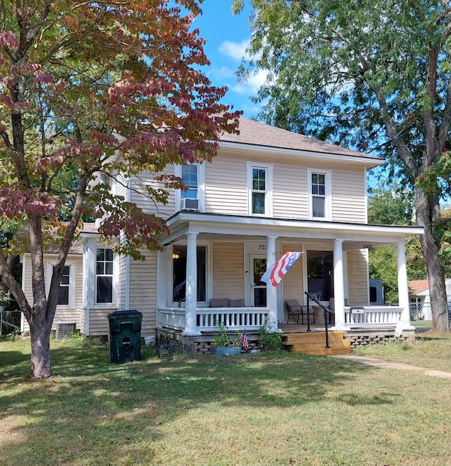 farmhouse inspired home featuring a front yard and covered porch