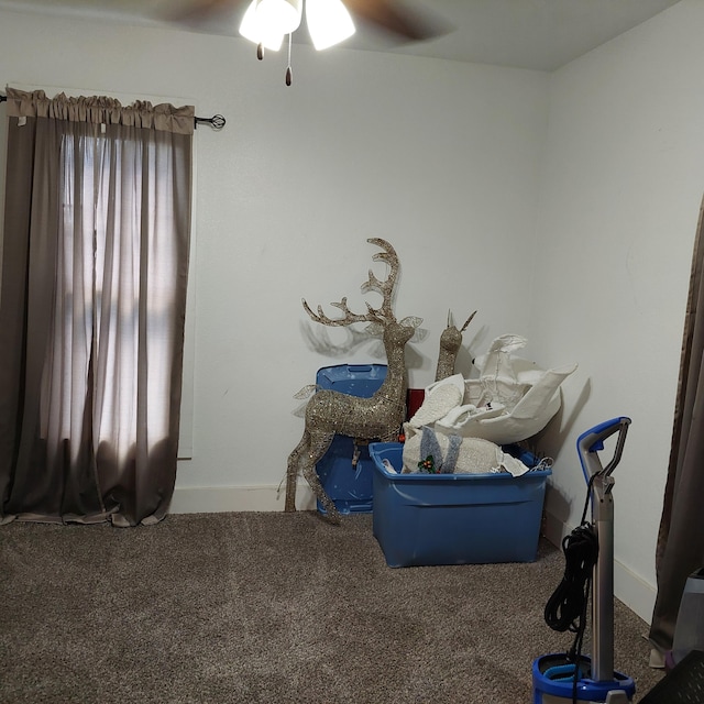 misc room with carpet flooring and ceiling fan