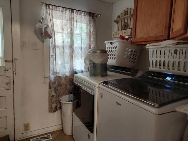 laundry area featuring cabinets and independent washer and dryer