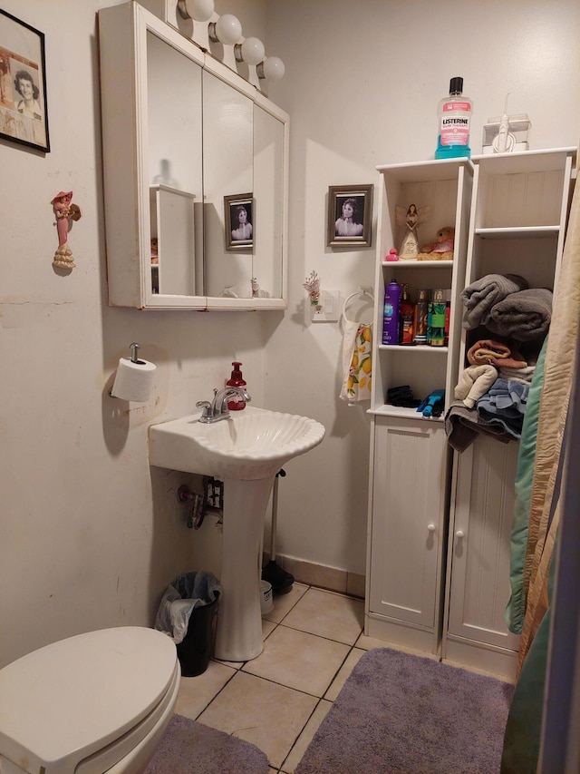 bathroom with tile patterned floors and toilet