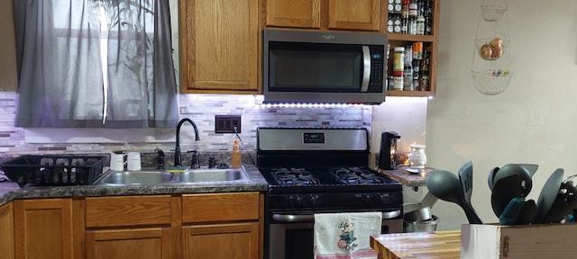 kitchen featuring stainless steel appliances, tasteful backsplash, and sink