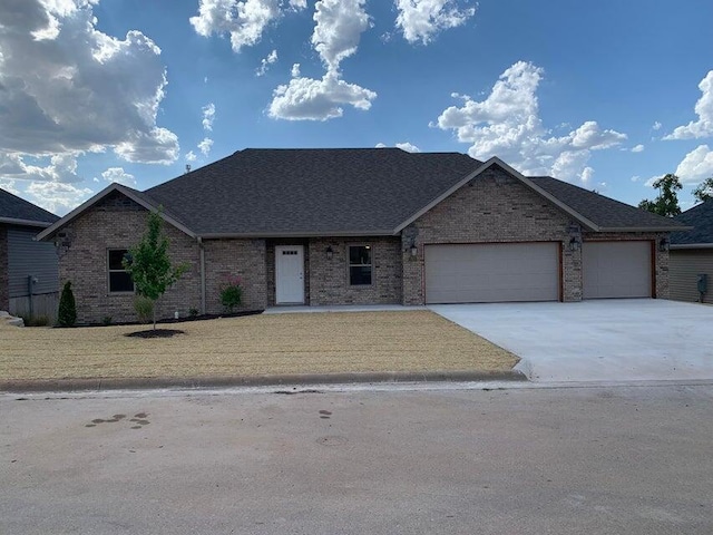 view of front of home featuring a garage and a front lawn