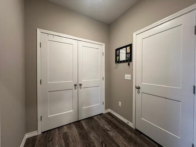 entryway with dark hardwood / wood-style floors