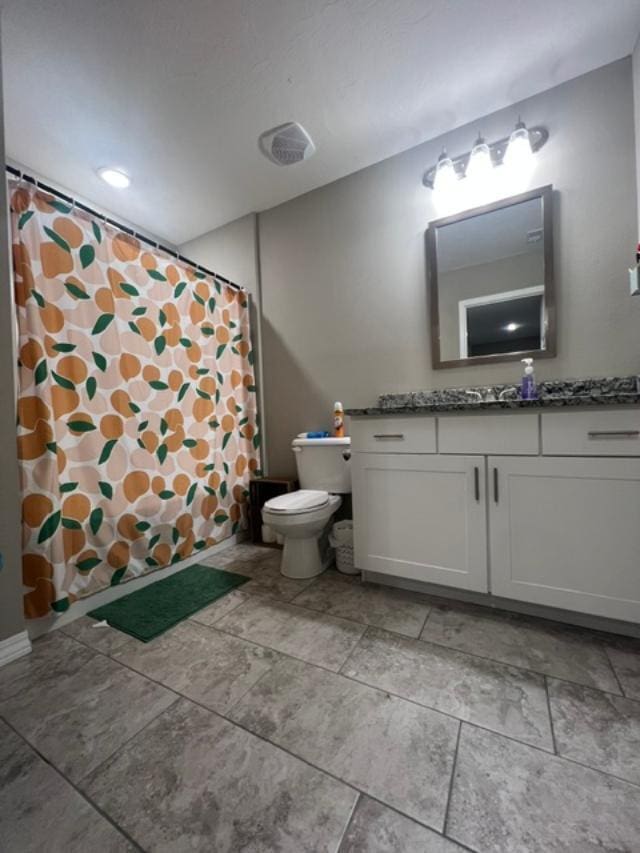 bathroom with vanity and toilet