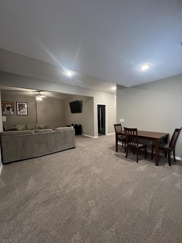 living room with ceiling fan and carpet flooring