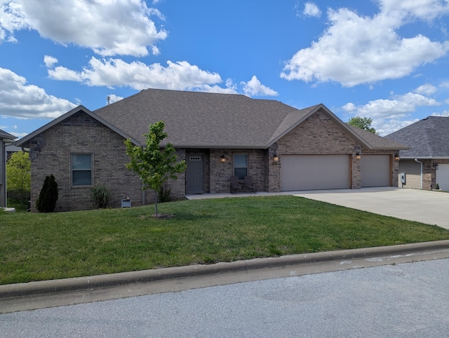 ranch-style house with brick siding, a garage, a front lawn, and concrete driveway