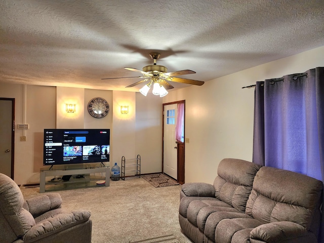 carpeted living room featuring a textured ceiling and ceiling fan