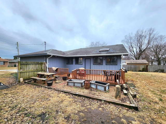 rear view of house with a wooden deck