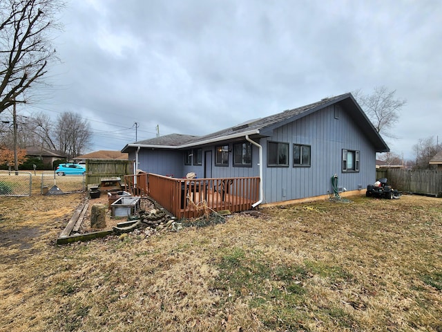 view of home's exterior with a wooden deck and a yard