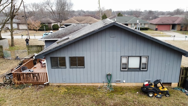 view of home's exterior featuring a deck and a lawn