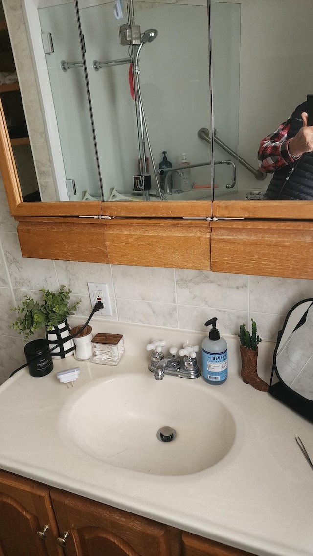 bathroom featuring tasteful backsplash and vanity