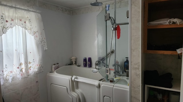 bathroom with washer / clothes dryer and separate shower and tub