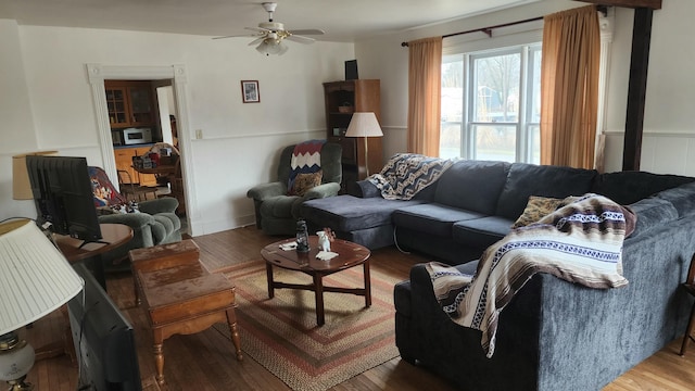 living room with hardwood / wood-style flooring and ceiling fan