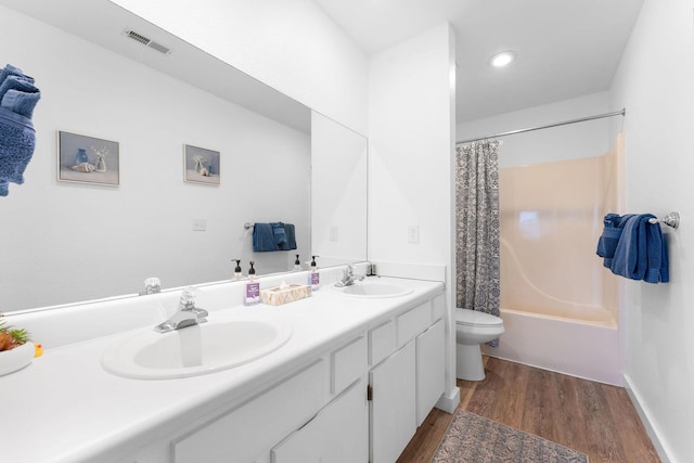 full bathroom with shower / bath combination with curtain, wood-type flooring, toilet, and vanity