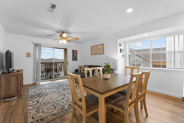 dining area with light hardwood / wood-style flooring and ceiling fan