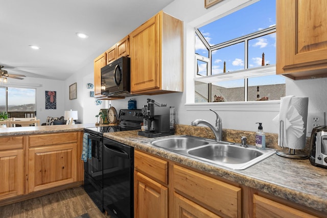 kitchen featuring dark hardwood / wood-style flooring, sink, black appliances, and ceiling fan