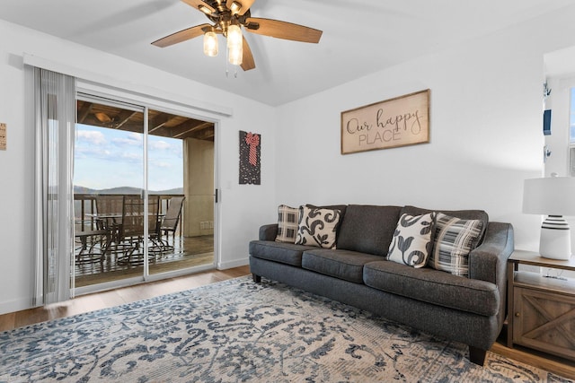 living room with ceiling fan and hardwood / wood-style floors