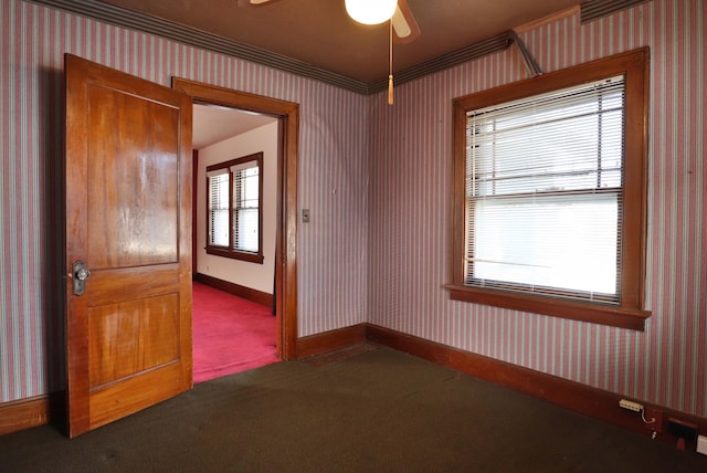 carpeted empty room with wallpapered walls, baseboards, and a ceiling fan