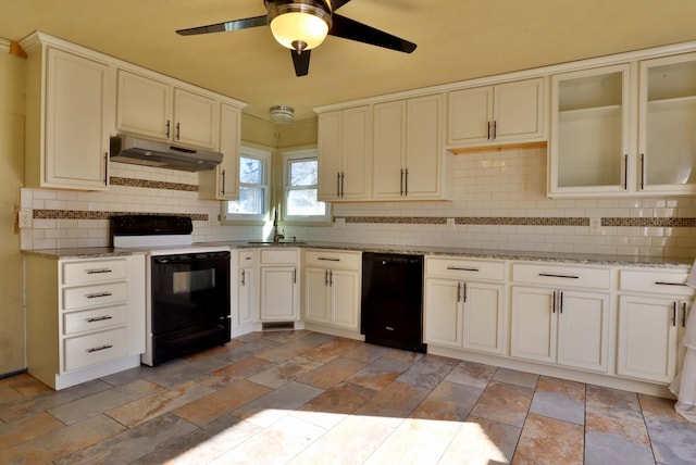 kitchen featuring under cabinet range hood, black dishwasher, electric stove, decorative backsplash, and stone finish floor