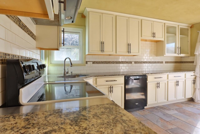 kitchen featuring black dishwasher, decorative backsplash, electric range oven, a sink, and light stone countertops