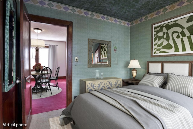 bedroom with baseboards, an inviting chandelier, carpet flooring, and wallpapered walls