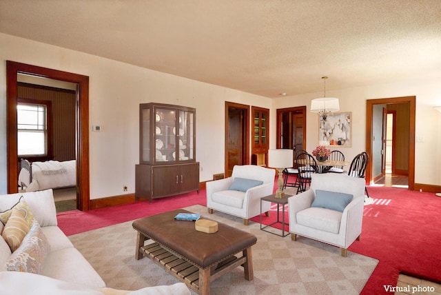 living area featuring light carpet, a textured ceiling, and baseboards