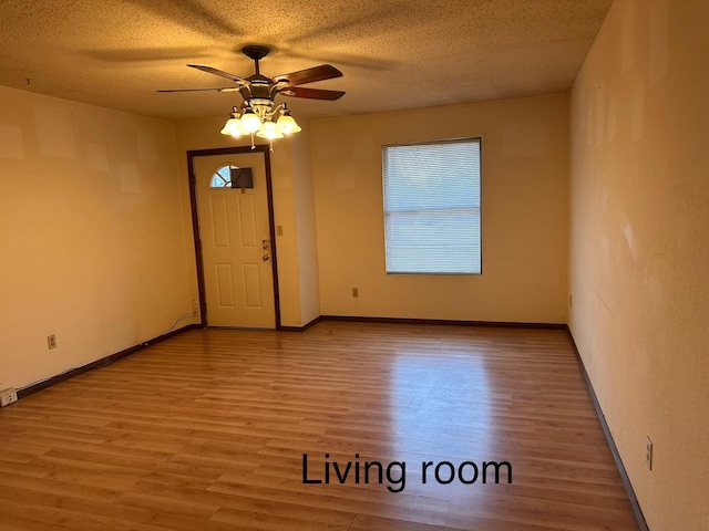 foyer with ceiling fan, a healthy amount of sunlight, light hardwood / wood-style flooring, and a textured ceiling