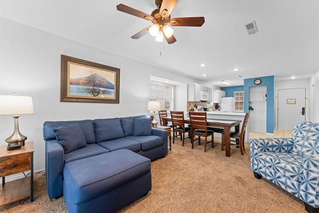 carpeted living room featuring ceiling fan