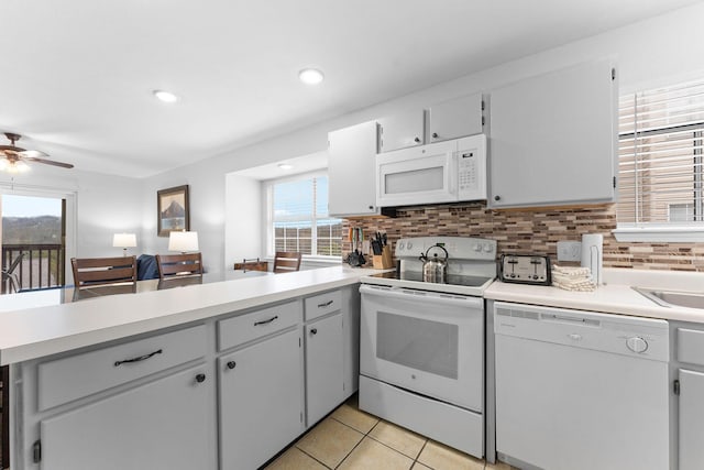 kitchen featuring tasteful backsplash, white appliances, light tile patterned flooring, and ceiling fan