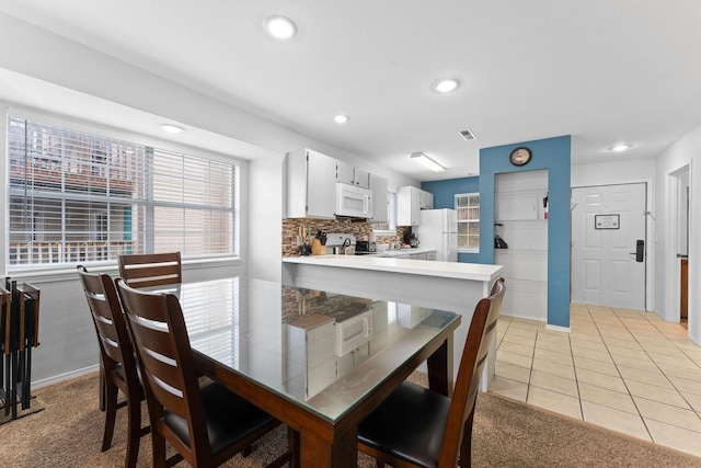 dining space featuring light tile patterned floors