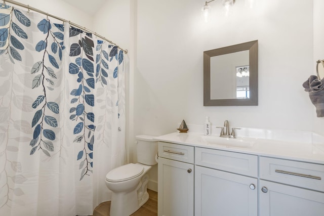 bathroom with a shower with shower curtain, vanity, toilet, and hardwood / wood-style floors