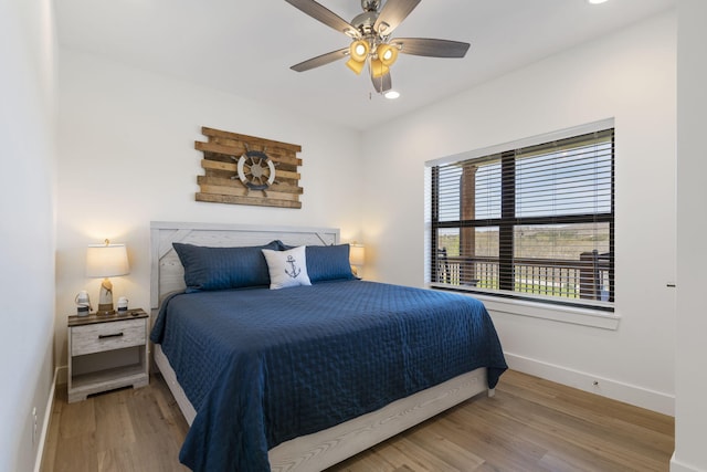 bedroom with wood-type flooring and ceiling fan