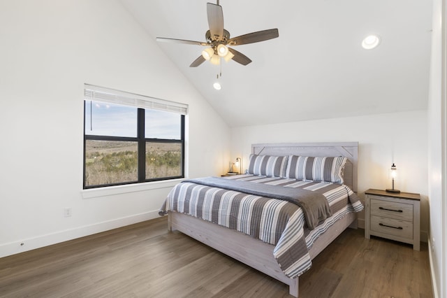 bedroom with hardwood / wood-style flooring, vaulted ceiling, and ceiling fan