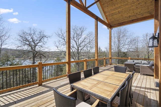 wooden terrace featuring outdoor lounge area and a water view