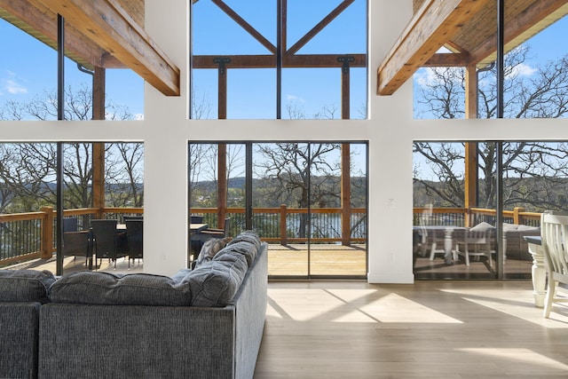 sunroom / solarium featuring beam ceiling