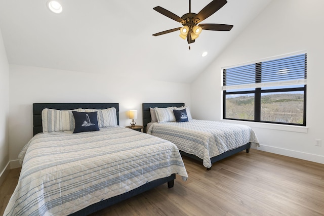 bedroom featuring hardwood / wood-style flooring, ceiling fan, and vaulted ceiling