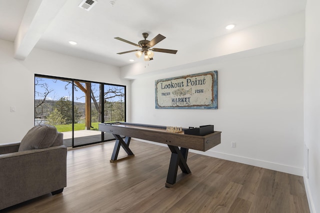 rec room featuring beamed ceiling, dark hardwood / wood-style floors, and ceiling fan