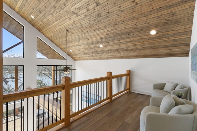 interior space with dark wood-type flooring, ceiling fan, wood ceiling, and high vaulted ceiling