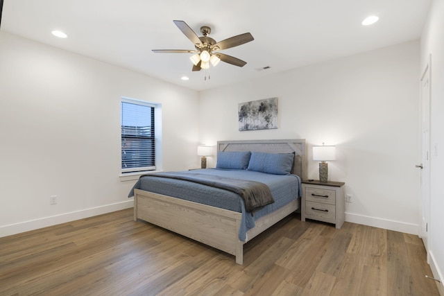 bedroom with hardwood / wood-style flooring and ceiling fan