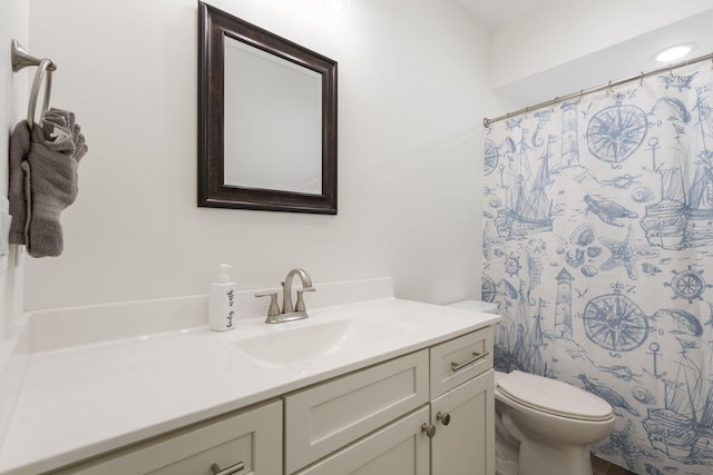 bathroom with vanity, a shower with shower curtain, and toilet