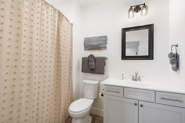 bathroom with a shower with curtain, vanity, and toilet