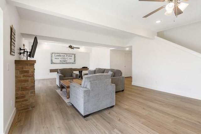 living room featuring light hardwood / wood-style floors and ceiling fan