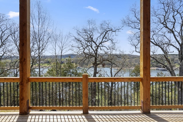 wooden terrace featuring a water view