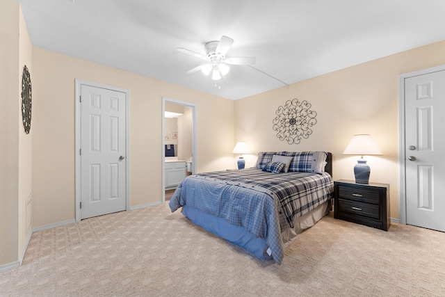 carpeted bedroom featuring ceiling fan and ensuite bathroom